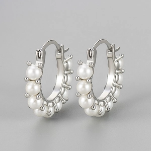 Elegant silver hoop earrings featuring multiple round white pearls on a minimalist frame
