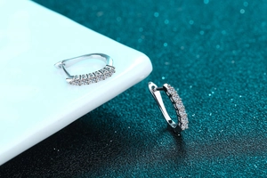 Macro detail of silver hoop earrings with single row pavé set moissanite stones