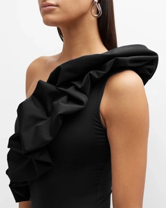 Detail of the black one-shoulder swimsuit with elegant cascading ruffle and matte finish