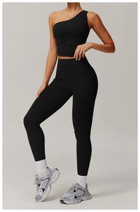 Black one-shoulder yoga set featuring high-waist leggings and a slimming sports bra
