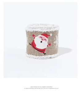 Close-up of burlap Christmas ribbon with white faux fur edges and Santa Claus print