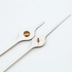 Brushed silver quartz clock hands with golden brass mount on white background