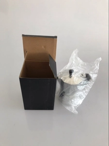 Detailed view of the aluminum moka pot stored in a protective bag with its black carton box