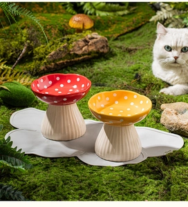 Detail of mushroom-shaped ceramic cat bowls with non-slip silicone pads on forest moss background