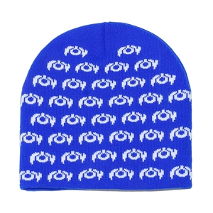 Macro detail of dark blue knit beanie with white jacquard monster pattern texture