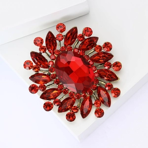 Luxury sunburst brooch with red faceted crystal and rhinestones in vintage gold finish