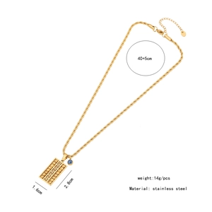 Detail view of gold stainless steel geometric pendant necklace with evil eye charm