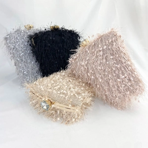 Macro detail of luxury fringe clutch bag with crystal gemstone clasp in various colors