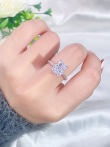 Close-up of a square ice-cut radiant diamond silver ring on model's hand