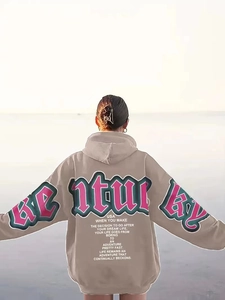 Detail of the oversized taupe hoodie featuring white vintage artistic back lettering