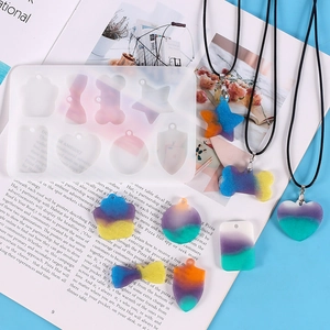 Macro view of geometric silicone mold with colorful glitter resin heart and star pendants