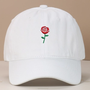 Close-up of red rose flower embroidery on a classic white cotton baseball cap