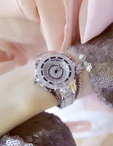 Close-up of sparkling diamond-encrusted women's watch and butterfly bracelet set