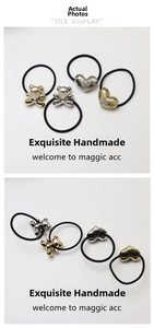 Detail of bear and heart charms on elastic hair ties with sparkling crystal accents
