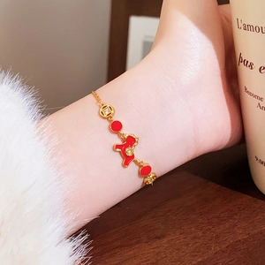 Close-up of 18k gold plated bracelet featuring red enamel dragon and coin charms