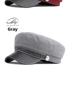 Close-up of wool gray sailor cap with black leather brim and silver button detail
