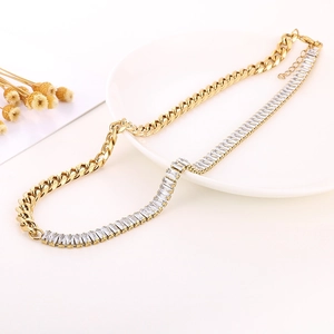 Detail of 18K gold Cuban link necklace combined with rectangular cubic zirconia tennis chain