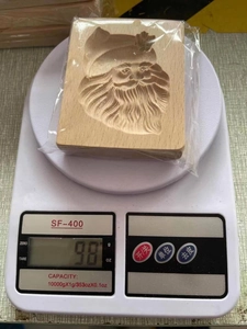 Detailed weight measurement of a Santa Claus engraved rectangular wooden cookie mold