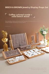 Detail view of beech wood and coffee velvet jewelry display stands for necklaces and rings