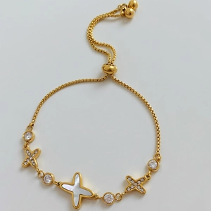Adjustable gold star and cross bracelet set with mother of pearl and cubic zirconia charms
