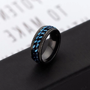 Macro shot of a black stainless steel spinner ring with a blue Cuban chain inlay