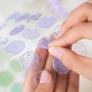 Translucent purple candy-style wax seal stickers with embossed floral and Best Wish designs