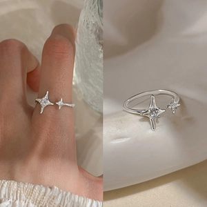 Detailed view of an adjustable star ring with inlaid cubic zirconia and silver finish