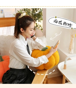 Close-up of plush pumpkin pillow featuring soft sherpa fabric and realistic green stem