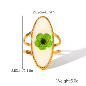 Detailed view of oval gold ring featuring green dried flower with size and weight specs