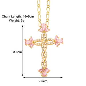 Detail of gold cross pendant with pink stones showing size dimensions and chain length