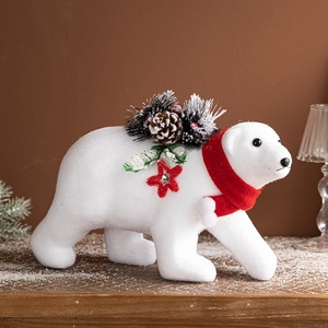 White flocked Christmas polar bear figurine with red scarf and pine cone decorations