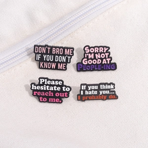 Set of 4 black enamel pins with sarcastic English quotes on a white canvas background