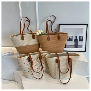 Knitted bucket tote bag with leather handles in minimalist beige and khaki tones