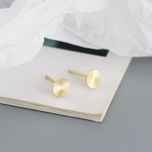 Detail of high-quality S925 sterling silver gold round stud earrings with radial texture