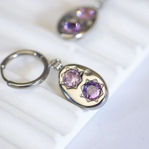 Vintage silver earrings with purple round gemstones and star-shaped engraving details