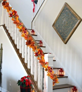 Autumn maple leaf garland draped on a white staircase for Thanksgiving decoration