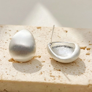 Brushed silver waterdrop stud earrings with matte texture and minimalist vintage design