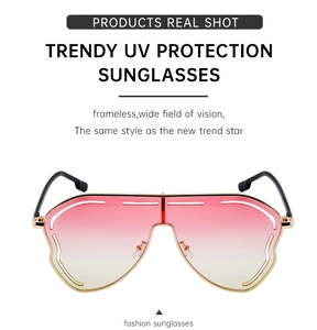 Detail of oversized rimless gradient sunglasses with gold metal temples and UV protection