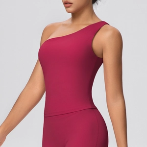 Detail of one-shoulder yoga tank top in deep rose red with high elasticity sports fabric