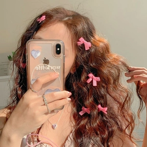 Sweet pink mini ribbon bow hair clips set on a model for a fresh feminine hairstyle