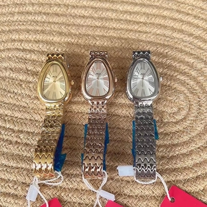 Detailed view of three luxury snake-head watches in gold, rose gold, and silver finishes