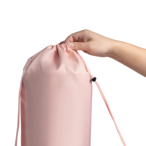 Close-up of pink yoga mat bag showing drawstring closure and durable fabric detail