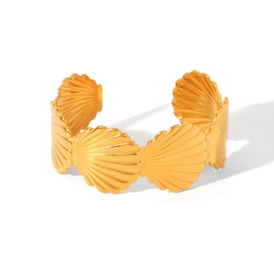 Detail view of 18K gold plated stainless steel cuff bracelet with scalloped shell texture