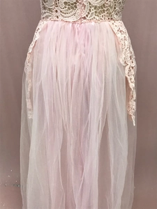 Close-up of pink lace bodice and tiered mesh skirt detailing on this elegant summer dress