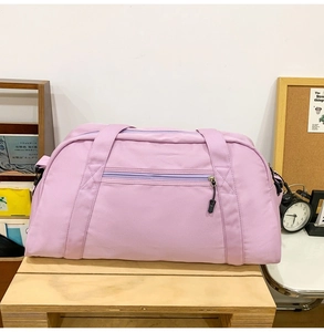 Large capacity lavender sports gym bag with front zipper pocket in a lifestyle setting