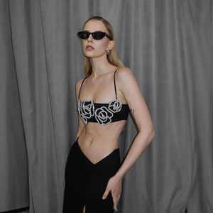 Chic black two-piece set with rhinestone rose crop top and high waist slit skirt