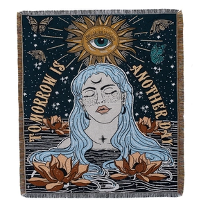 Bohemian woven camping blanket featuring sun, lotus, and butterfly art on a blue background