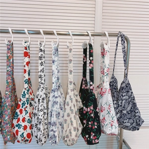 Detail of assorted floral canvas tote bags with vintage paisley and tulip patterns