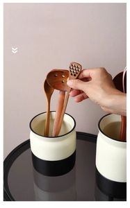 Detail of Nordic ceramic utensil holder featuring a modern black and white dual-tone design
