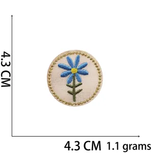 Detail of blue daisy embroidery patch with gold wavy edges and 4.3cm dimension measurement